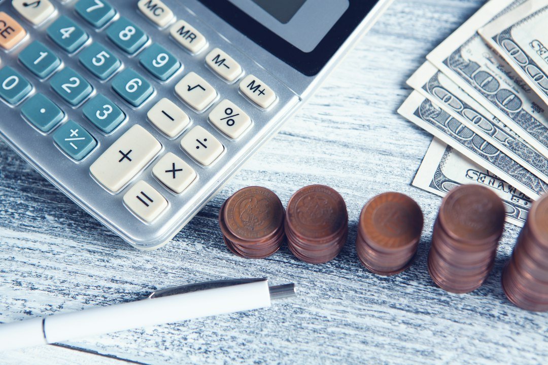 Home a-calculator-pen-and-money-on-a-table-x4vwfpzy-2o