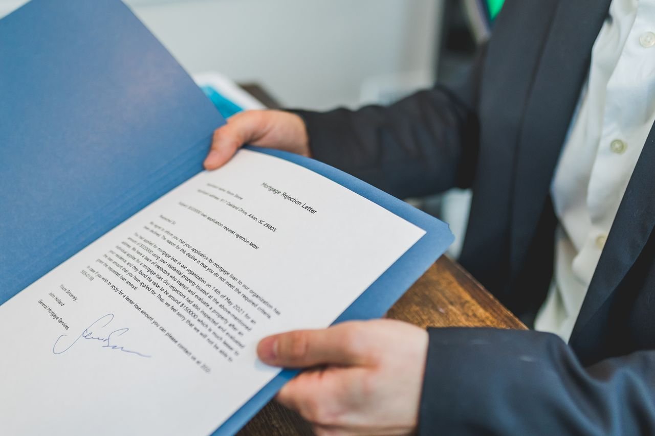 Home Closeup of a real estate contract being reviewed by an agent and client.